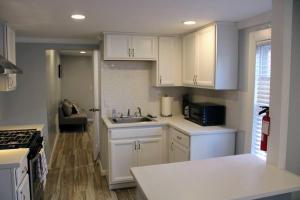 a kitchen with white cabinets and a sink at The Clark - Suite 1W - Ocean Grove near Asbury in Ocean Grove