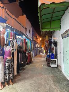 an alley of a store with clothes and other shops at Casa Hassan in Asilah