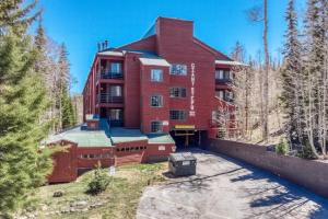 a large red building with trees in front of it at Premium Ski In Ski Out At Giants Steps Chairlift! in Brian Head