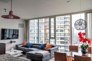 a living room with a couch and a large window at LuxeStay in Vancouver