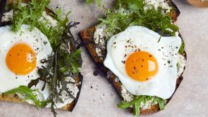 two eggs on top of bread with greens on top at Hotel Boutique Siete Lunas in Sayulita