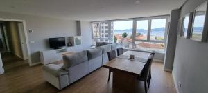 a living room with a couch and a table at Vigo al Mar in Vigo