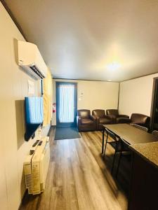 a conference room with chairs and a table and a tv at Glen Garry motel and cottages in North Bay