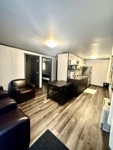 a living room with a table and a couch at Glen Garry motel and cottages in North Bay