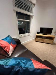 a living room with a couch and a television at Spacious 2Bed/2Bath Flat next to London Eye in London
