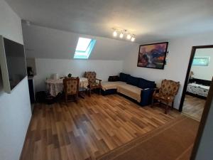 a living room with a couch and a table at Cazare Adela in Horezu
