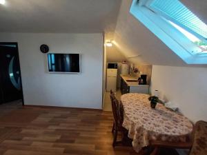a dining room with a table and a kitchen at Cazare Adela in Horezu
