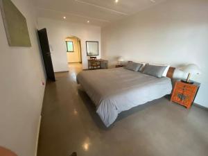 a bedroom with a large white bed in a room at Amasundu Beach House Trafalgar in Southbroom