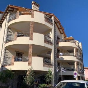 a building with balconies on the side of it at Residenza Petrera in Muravera