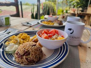 a table with a plate of food on a table at Los Tucanes Lodging in El Castillo de La Fortuna