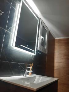 a bathroom with a sink with a window above it at XANTHI'S 4 LIVING in Athens