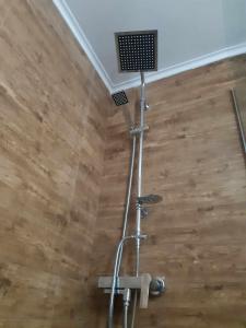 a shower head in a room with a wooden floor at XANTHI'S 4 LIVING in Athens