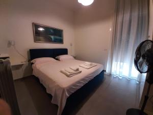 a bedroom with a bed with two towels on it at Casa Ricordi in Vietri sul Mare