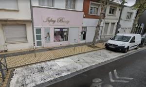 a white van parked in front of a store at Naturally Suite in Calais