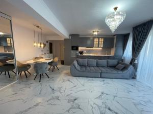 a large living room with a couch and a table at SunSet Apartament in Oradea