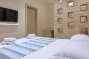 Postel nebo postele na pokoji v ubytování Hotel Maksim