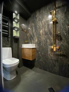 a bathroom with a toilet and a sink at Hotel Villa Niko Mari in Tbilisi City
