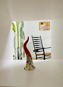 a figurine of a bird sitting on a table in a room at MaNà Rooms and Apartment in Telese