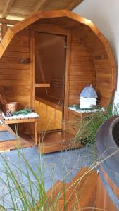 a large wooden dog house with a cake in it at Domek RiverHut - w ogrodzie Balia z Jacuzzi in Małe Ciche