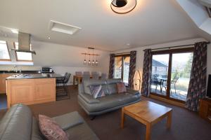 a living room with a couch and a table at Aikbeck Lodge in Penrith