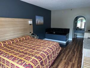 a hotel room with a bed and a bath tub at Jameson Inn Conyers in Conyers