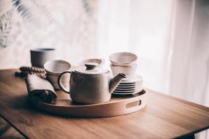 a tray with cups and plates on a table at Marinero Apartament in Puck