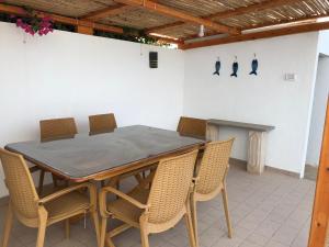 a table and chairs in a patio with a fireplace at VILLA ALOHA DJERBA plain pied haut de gamme piscine proche de la plage in Midoun