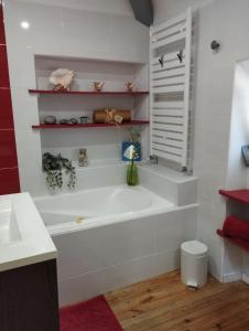 a white bathroom with a tub and a sink at PEGASUS in Blainville-sur-Orne