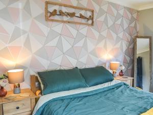 a bedroom with a bed and a geometric wall at Seaside Dreams in Bessingby