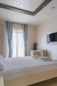 Postel nebo postele na pokoji v ubytování Hotel Maksim