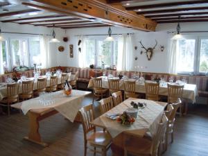 a dining room with tables and chairs in it at Klosterweiherhof in Dachsberg im Schwarzwald