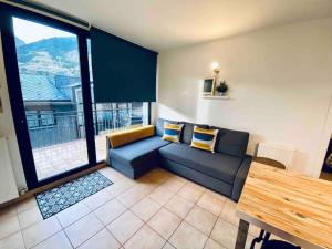 a living room with a couch and a table at APARTAMENTO CANILLO Wifi-Parquing free-Terraza HUT 5213 in Canillo