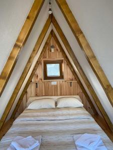 a bed in the middle of a roof at Bungalows and rooms Ivan in Žabljak