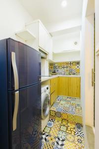 a kitchen with a refrigerator and a washer and dryer at Ta Hien 3 - Entire Apt-FREE Airport Pickup in Hanoi