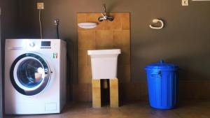 pralka i kosz na śmieci w łazience w obiekcie El Camín Real w mieście Rañeces