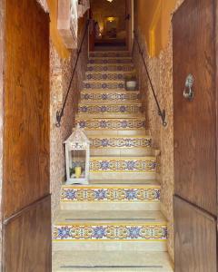a staircase with tiles on it with a lantern on it at B&b Torretta San Giovanni a Corte in Sant'Agata de' Goti