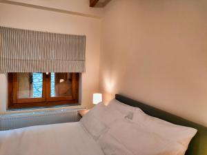 a bedroom with a white bed and a window at Elegant Vista Residence in Metsovo