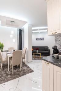 a kitchen and living room with a table and chairs at Top Central Apartment & Free Parking in Sofia
