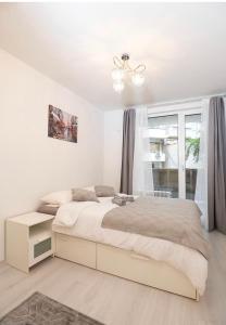 um quarto branco com uma cama e uma janela em Top Central Luxury Apartment & Free Parking em Sófia