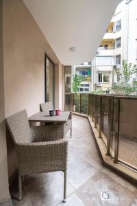 a balcony with a table and chairs in a building at Top Central Luxury Apartment & Free Parking in Sofia