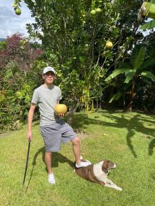 a man standing next to a dog on the grass at Cloud forest SAN CARLOS in La Merced