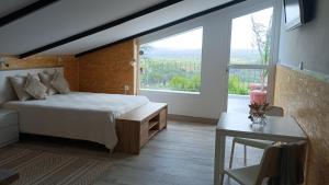 a bedroom with a bed and a large window at Casa Gabriel in Picassent