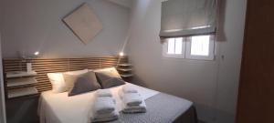 sypialnia z łóżkiem i ręcznikami w obiekcie ZEUS BEACH Apartament w mieście Torrevieja