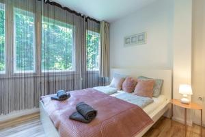 a bedroom with a large bed with two hats on it at Gems of Budapest - Tiger Eye Residence in Budapest