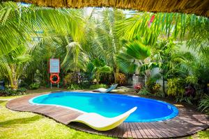 una piscina in un cortile con due sedie di Preety Blue Residence villas a Grand Baie