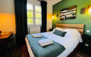 a bedroom with a bed with two towels on it at L'Escoundillou in Saint-Jacques-des-Blats