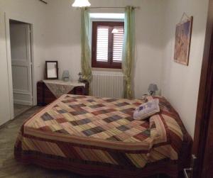 a bedroom with a bed and a window at Masseria Spadone in Civitella Casanova