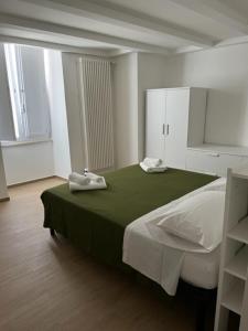 a bedroom with a bed with two towels on it at Dimora Dilù in Noci
