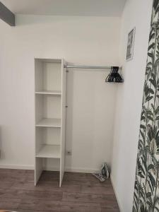 a white closet in a room with white walls at Petite maison Juvisy, Orly 7 min, Paris 15min in Juvisy-sur-Orge