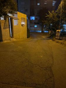 an empty street next to a building at night at בית נופש בוטיק - Boutique holiday home in Bayit Wegan